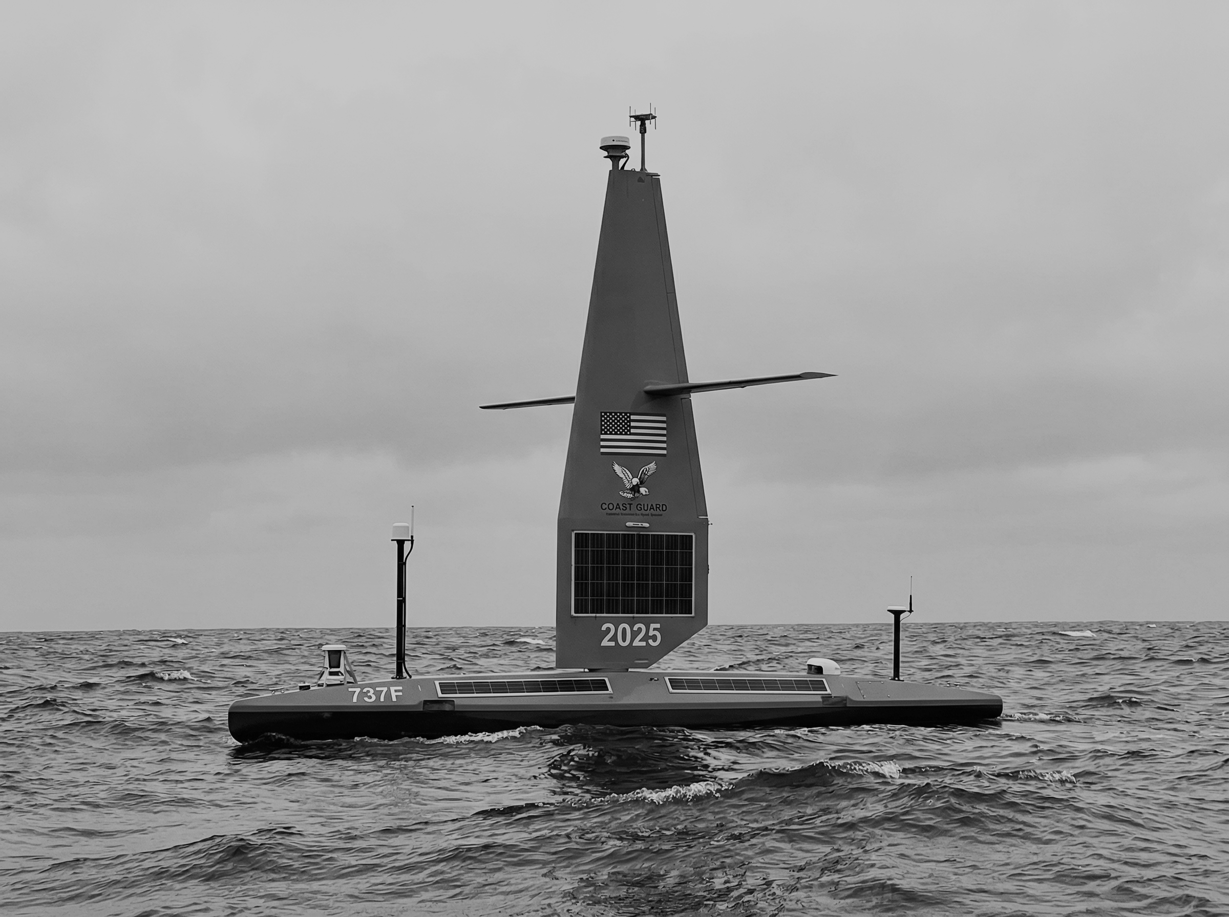 Three low-profile autonomous maritime vessels navigating heavy water
